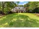 Two-story traditional home with mature trees, large lawn and covered front porch at 220 Broadmoor Dr, Fayetteville, GA 30215