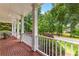 Charming covered porch with brick flooring and cozy seating, ideal for relaxing outdoors at 220 Broadmoor Dr, Fayetteville, GA 30215
