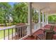 Inviting front porch with brick flooring and seating area overlooking the front yard at 220 Broadmoor Dr, Fayetteville, GA 30215