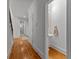 Bright hallway with hardwood floors leads to a convenient half bathroom at 220 Broadmoor Dr, Fayetteville, GA 30215