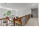 Well-lit hallway showcasing architectural details, a view of the living area, and a large window at 220 Broadmoor Dr, Fayetteville, GA 30215