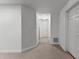 Finished basement hallway with neutral carpet and white walls at 220 Broadmoor Dr, Fayetteville, GA 30215