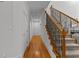 Bright hallway features hardwood floors, white walls, and a staircase with black wrought iron spindles at 220 Broadmoor Dr, Fayetteville, GA 30215