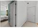 Bright hallway with white trim, doors, and a view into a bedroom with a ceiling fan at 220 Broadmoor Dr, Fayetteville, GA 30215