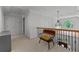 Upstairs hallway with views of a window, chandelier, and chair, offering a glimpse of the home's charm at 220 Broadmoor Dr, Fayetteville, GA 30215