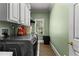 Functional laundry room with washer and dryer, overhead cabinets, and natural light from the window at 220 Broadmoor Dr, Fayetteville, GA 30215
