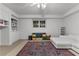 Bright basement living area with built-ins, storage, and large area rug at 220 Broadmoor Dr, Fayetteville, GA 30215