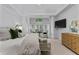 Bright main bedroom with a sitting area, neutral carpet, and large windows with plantation shutters at 220 Broadmoor Dr, Fayetteville, GA 30215