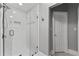 Bathroom featuring a glass enclosed walk-in shower with white tile and modern fixtures at 220 Broadmoor Dr, Fayetteville, GA 30215
