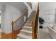 Elegant staircase with carpeted steps, wrought iron railings, and natural light, adjacent to the living area at 220 Broadmoor Dr, Fayetteville, GA 30215