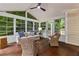 Cozy sunroom with lots of windows, wood floors and wicker furnishings at 220 Broadmoor Dr, Fayetteville, GA 30215