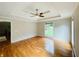 Spacious bedroom boasts hardwood floors, tray ceilings, a large window, and ample natural light at 345 Etheridge Rd, Auburn, GA 30011