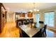 Open concept kitchen and dining area featuring stainless steel appliances, granite countertops, and hardwood floors at 345 Etheridge Rd, Auburn, GA 30011