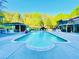 Backyard inground pool with sunbathing area, covered lounge, and outdoor kitchen at 345 Etheridge Rd, Auburn, GA 30011