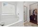 Bright bathroom with soaking tub, glass shower, and access to the walk in closet at 520 Edgemore Rd, Canton, GA 30114