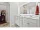 The bathroom has an illuminated mirror, a double sink, and a door to a closet at 520 Edgemore Rd, Canton, GA 30114