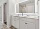 Bathroom featuring a double vanity, a large mirror, and an entrance to the shower at 520 Edgemore Rd, Canton, GA 30114