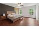 Bedroom featuring hardwood floors, a unique wall design, and great natural light at 520 Edgemore Rd, Canton, GA 30114