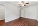 Empty bedroom with hardwood floors, ceiling fan, and ample closet space at 520 Edgemore Rd, Canton, GA 30114