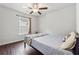Cozy bedroom with hardwood floors, a ceiling fan, and bright, natural light at 520 Edgemore Rd, Canton, GA 30114