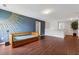 Bonus room area with an interesting headboard, hardwood floors, and a calming paint color at 520 Edgemore Rd, Canton, GA 30114