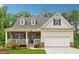 Charming single-Gathering home featuring a covered front porch, stone accents, and a two-car garage at 520 Edgemore Rd, Canton, GA 30114
