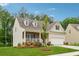 Beautiful home with a welcoming front porch, landscaped yard, and stone details on the facade at 520 Edgemore Rd, Canton, GA 30114