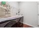 Laundry room with front load washer and dryer, wire shelving, and wood look floor at 520 Edgemore Rd, Canton, GA 30114