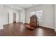 Bright living room with wood floors, a decorative cabinet, and easy access to the front entry at 520 Edgemore Rd, Canton, GA 30114