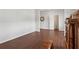 Open-concept living area with dark wood floors, neutral walls, and an adjacent hallway entrance at 520 Edgemore Rd, Canton, GA 30114