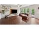 Spacious living room featuring hardwood floors, a plush sectional, and a TV console at 520 Edgemore Rd, Canton, GA 30114