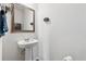 Bright powder room with sink, mirror, and adjacent wall mounted accessories at 520 Edgemore Rd, Canton, GA 30114