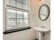 Bathroom with a pedestal sink, large window, and modern fixtures at 6895 Slate Stone Se Way # 3, Mableton, GA 30126