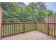 View of a wood deck overlooking a green, tree-filled backyard at 6895 Slate Stone Se Way # 3, Mableton, GA 30126