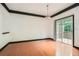Dining area with hardwood floors, a modern light fixture, and sliding glass doors to a private outdoor deck at 6895 Slate Stone Se Way # 3, Mableton, GA 30126