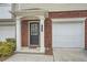 Inviting townhome entrance featuring brick facade, covered porch, black front door, and attached one car garage at 6895 Slate Stone Se Way # 3, Mableton, GA 30126