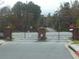 Gated entrance to the neighborhood with brick pillars and meticulously maintained roads with mature trees at 6895 Slate Stone Se Way # 3, Mableton, GA 30126