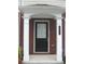 A covered entrance to the home showing brick accents, white columns and a black door with a window at 6895 Slate Stone Se Way # 3, Mableton, GA 30126