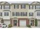 Attractive townhome featuring tan siding, brick accents, black shutters, attached garages and a welcoming front entrance at 6895 Slate Stone Se Way # 3, Mableton, GA 30126