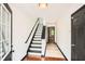 Hallway with hardwood floors leading to a staircase with black and white accents at 6895 Slate Stone Se Way # 3, Mableton, GA 30126