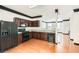 Modern kitchen with stainless steel appliances, dark cabinets, and a view to the living room at 6895 Slate Stone Se Way # 3, Mableton, GA 30126