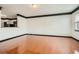 Bright living room with hardwood flooring, neutral paint, and an open layout leading into the kitchen area at 6895 Slate Stone Se Way # 3, Mableton, GA 30126