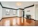 Open-concept living room with glossy hardwood floors, a fireplace, and neutral walls for versatile decorating at 6895 Slate Stone Se Way # 3, Mableton, GA 30126