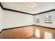 Bright living room with hardwood floors, white walls, dark trim, and large windows offering natural light at 6895 Slate Stone Se Way # 3, Mableton, GA 30126