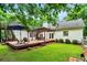 Backyard featuring a large deck, outdoor seating under a pergola, and mature trees at 7212 Avalon Dr, Douglasville, GA 30135