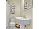 Charming half bathroom featuring a pedestal sink and updated fixtures at 7212 Avalon Dr, Douglasville, GA 30135