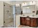 Bathroom boasts double vanity sinks with dark wood cabinets and large walk-in shower at 7212 Avalon Dr, Douglasville, GA 30135