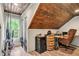 Bonus room with wood-paneled ceiling and floor, window, and decorative barrels at 7212 Avalon Dr, Douglasville, GA 30135