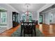 Elegant dining room with hardwood floors, decorative chandelier, and large windows providing plenty of natural light at 7212 Avalon Dr, Douglasville, GA 30135