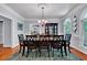 Formal dining room with a table, chairs, and chandelier; features hardwood floors and white trim at 7212 Avalon Dr, Douglasville, GA 30135